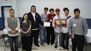 Dennis Franklin Cromarty High School Students receiving OKT Award at Our Way Conference, to sponsor their travel and attendance: (from L to R): Brandon Wright and Tara Lynne Vesa (teachers, DFCHS), Luke Aysanabee (Deer Lake First Nation), Davery Bottle (Mishkeegogamang First Nation), Lorraine Land, Gilbert Fiddler (Sandy Lake First Nation), Tyrell Fiddler (Sandy Lake First Nation) and John Anderson (Thunder Bay) at Awards Banquet at Our Way Conference.